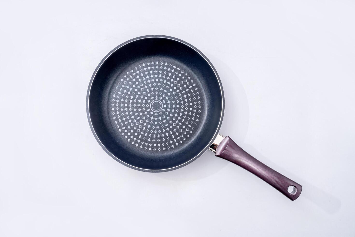 Top view of new empty frying pan isolated on white photo