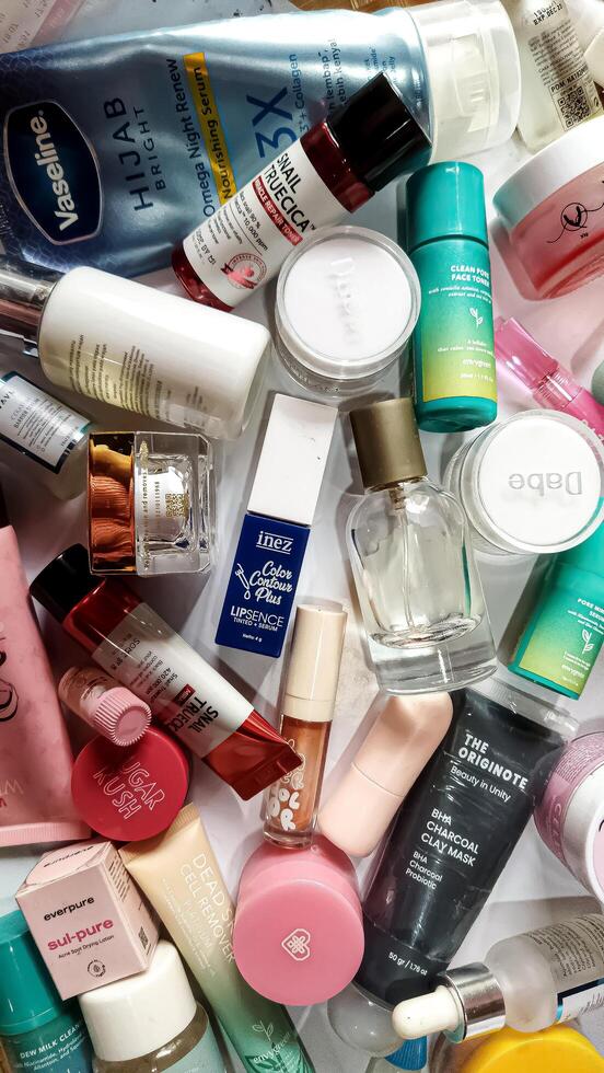Surakarta, Indonesia - Desember 15, 2024. Many used bottles and jars for different brandy feminines. Containers for shampoo and lotions, cans for creams and face masks photo