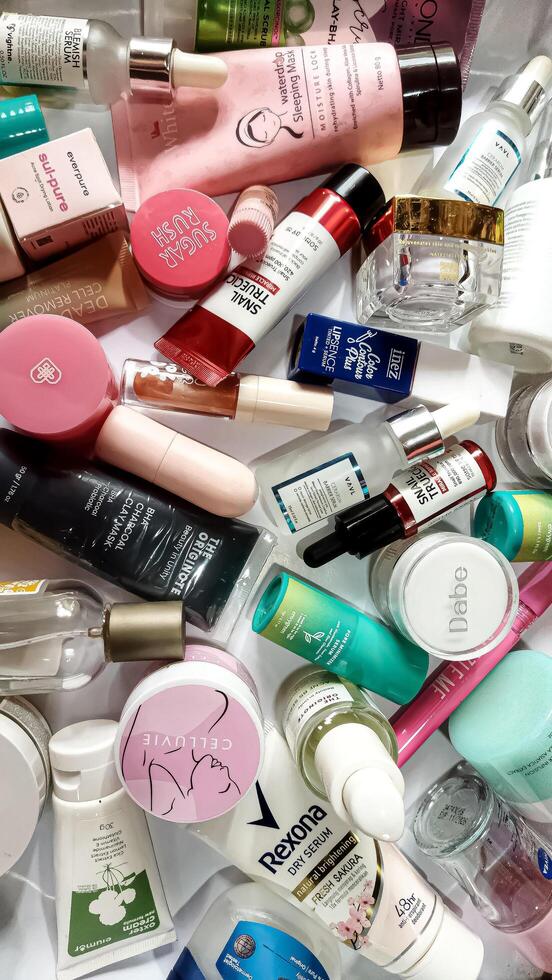 Surakarta, Indonesia - Desember 15, 2024. Many used bottles and jars for different brandy feminines. Containers for shampoo and lotions, cans for creams and face masks photo