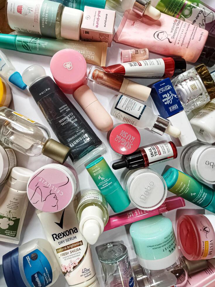 Surakarta, Indonesia - Desember 15, 2024. Many used bottles and jars for different brandy feminines. Containers for shampoo and lotions, cans for creams and face masks photo
