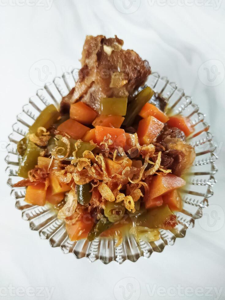 Asem-asem Daging or Vegetable Sour Beef Soup is typical dish of Java, Indonesia. With beef, carrot and beans as ingredients plus Javanesse starfruit. photo