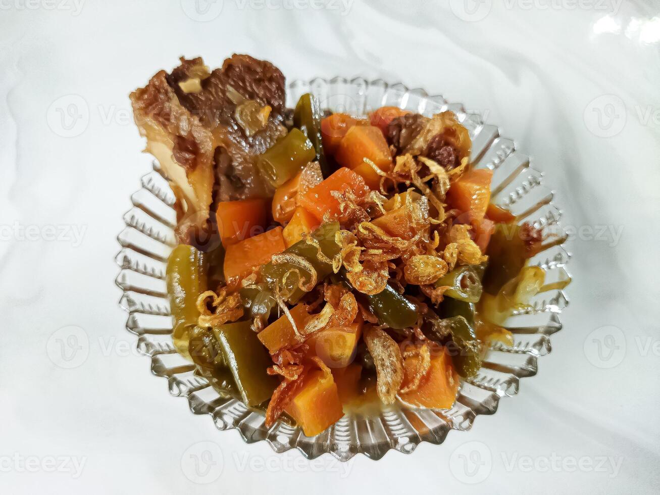 Asem-asem Daging or Vegetable Sour Beef Soup is typical dish of Java, Indonesia. With beef, carrot and beans as ingredients plus Javanesse starfruit. photo