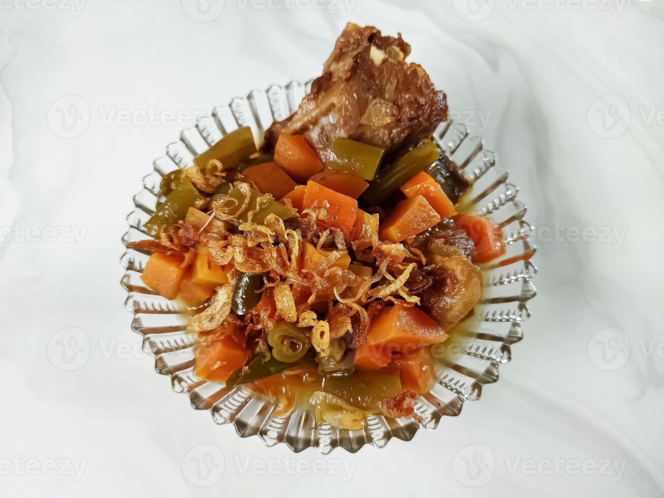 Asem-asem Daging or Vegetable Sour Beef Soup is typical dish of Java, Indonesia. With beef, carrot and beans as ingredients plus Javanesse starfruit. photo