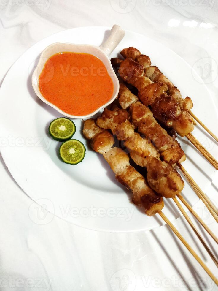 Sate taichan or taichan satay, Made from chicken meat. Served with Sauce and lime. photo