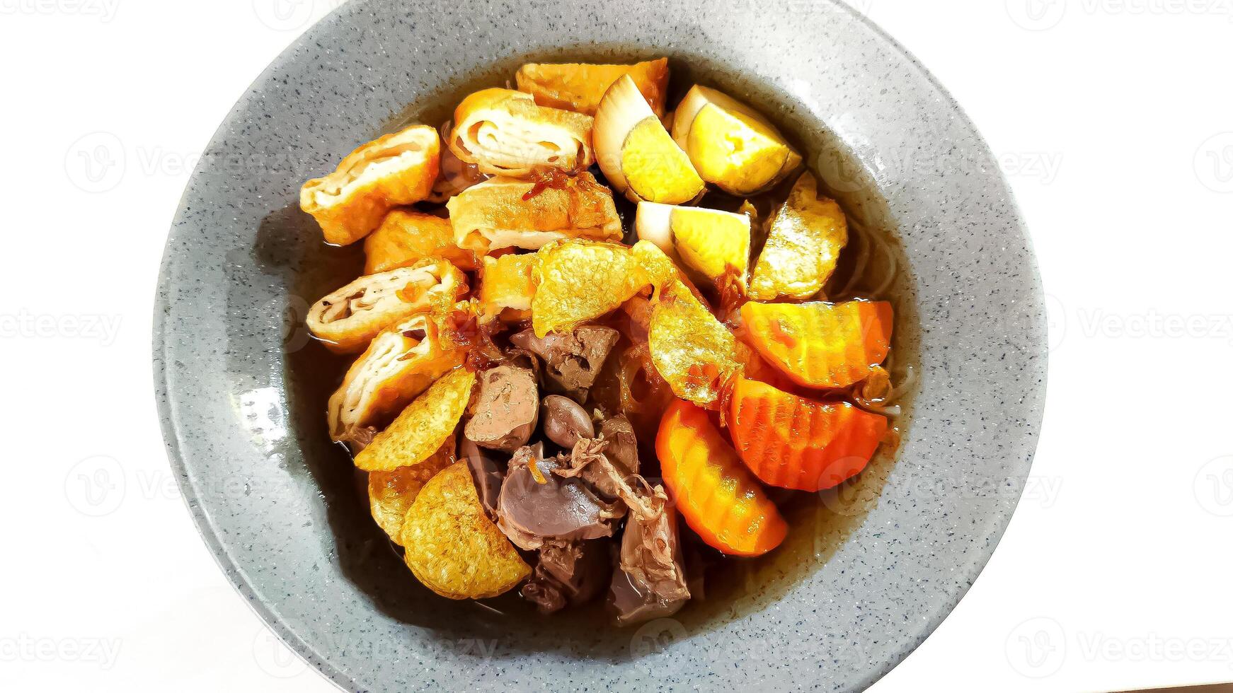 Timlo is a soup, containing sliced chicken gizzard liver, sliced rolled omellete, sliced solo sausage, vermicelli, boiled egg and shredded fried chicken. photo