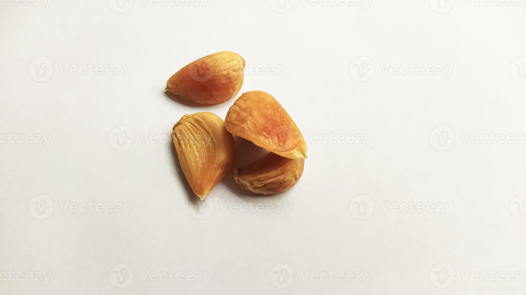 Garlic that turns into golden garlic has a slightly transparent golden yellow color, with a soft texture that tends to be sticky. Golden garlic isolated on white background. photo