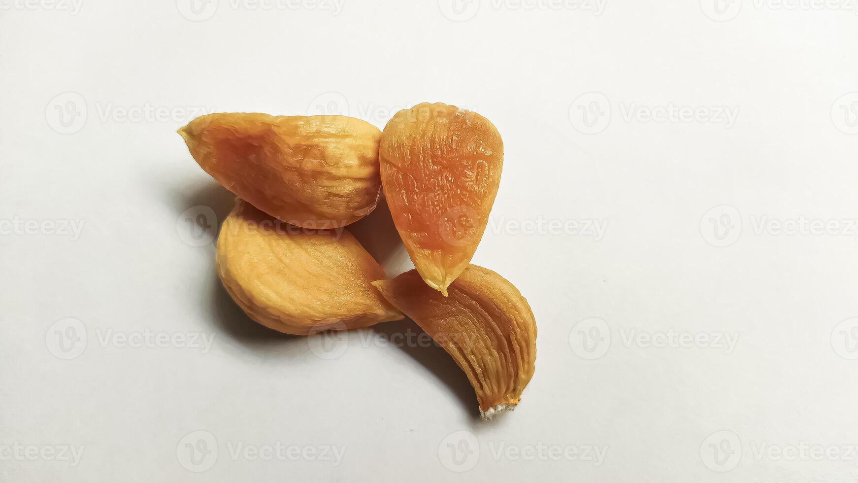 Garlic that turns into golden garlic has a slightly transparent golden yellow color, with a soft texture that tends to be sticky. Golden garlic isolated on white background. photo