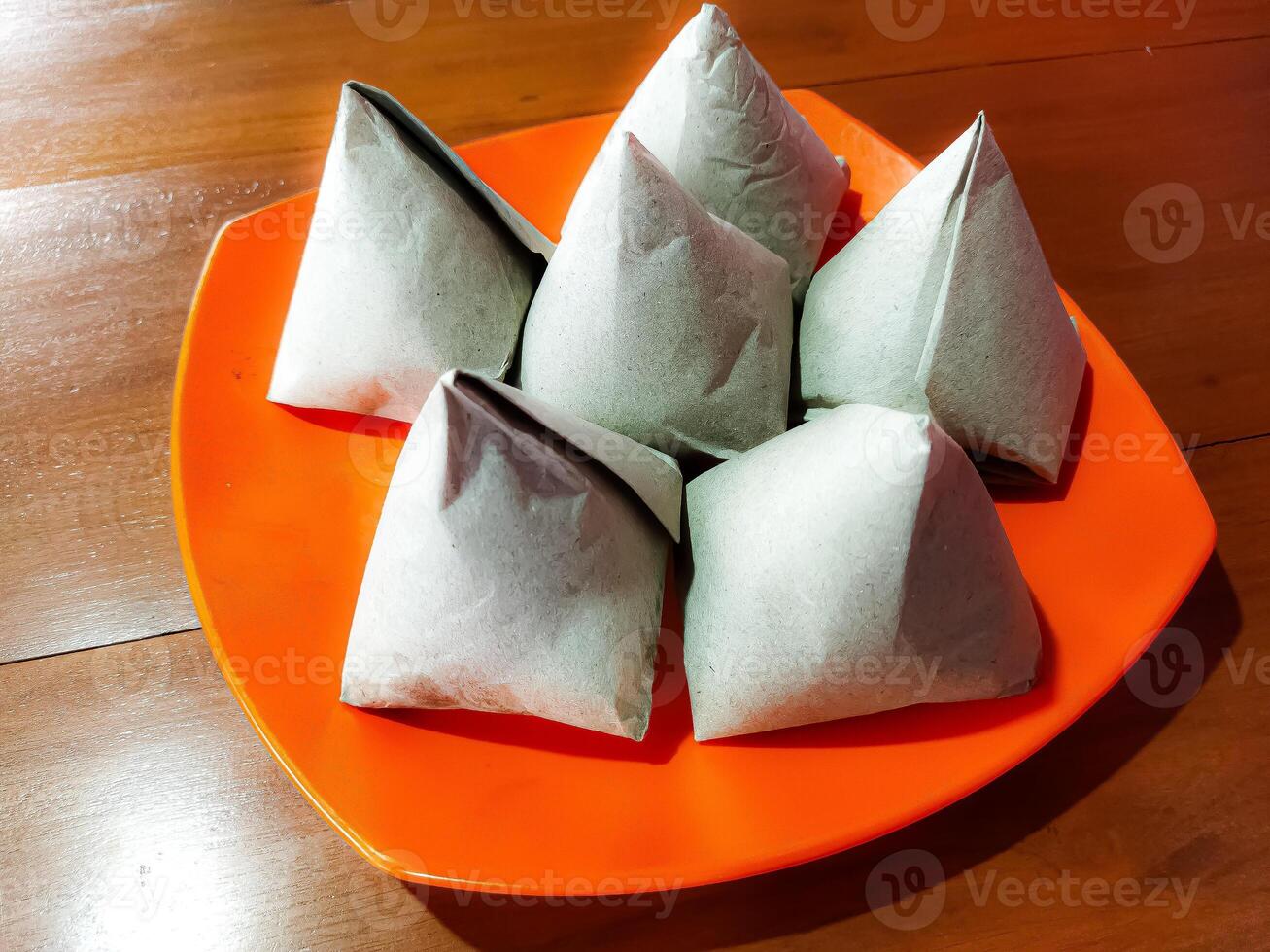 Nasi Kucing. Popular snack rice dish in small portion, topped with variety of toppings photo