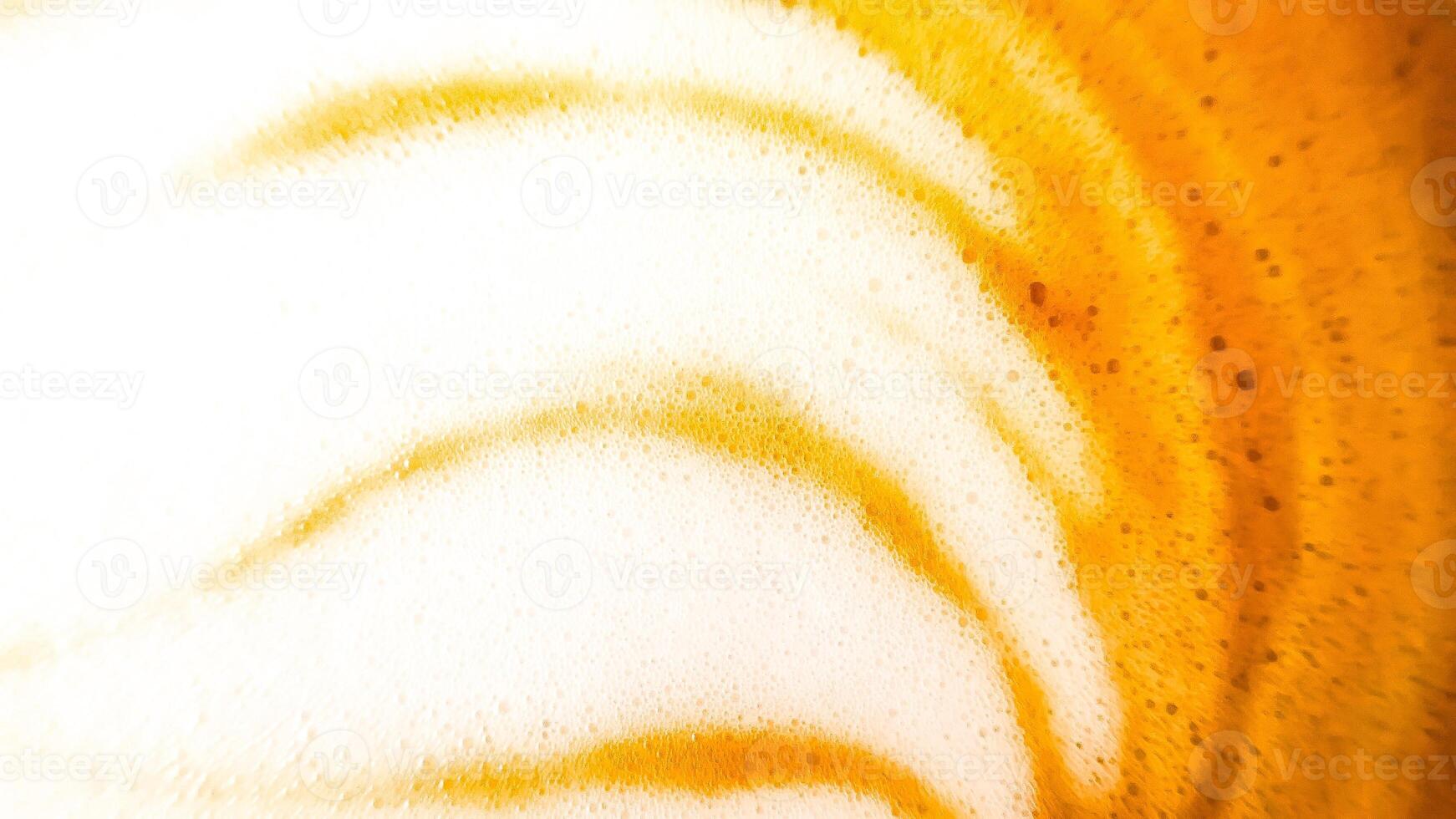 High-angle full-frame shot of coffee and milk swirling together, featuring frothy foam bubbles and creating a captivating abstract pattern. photo