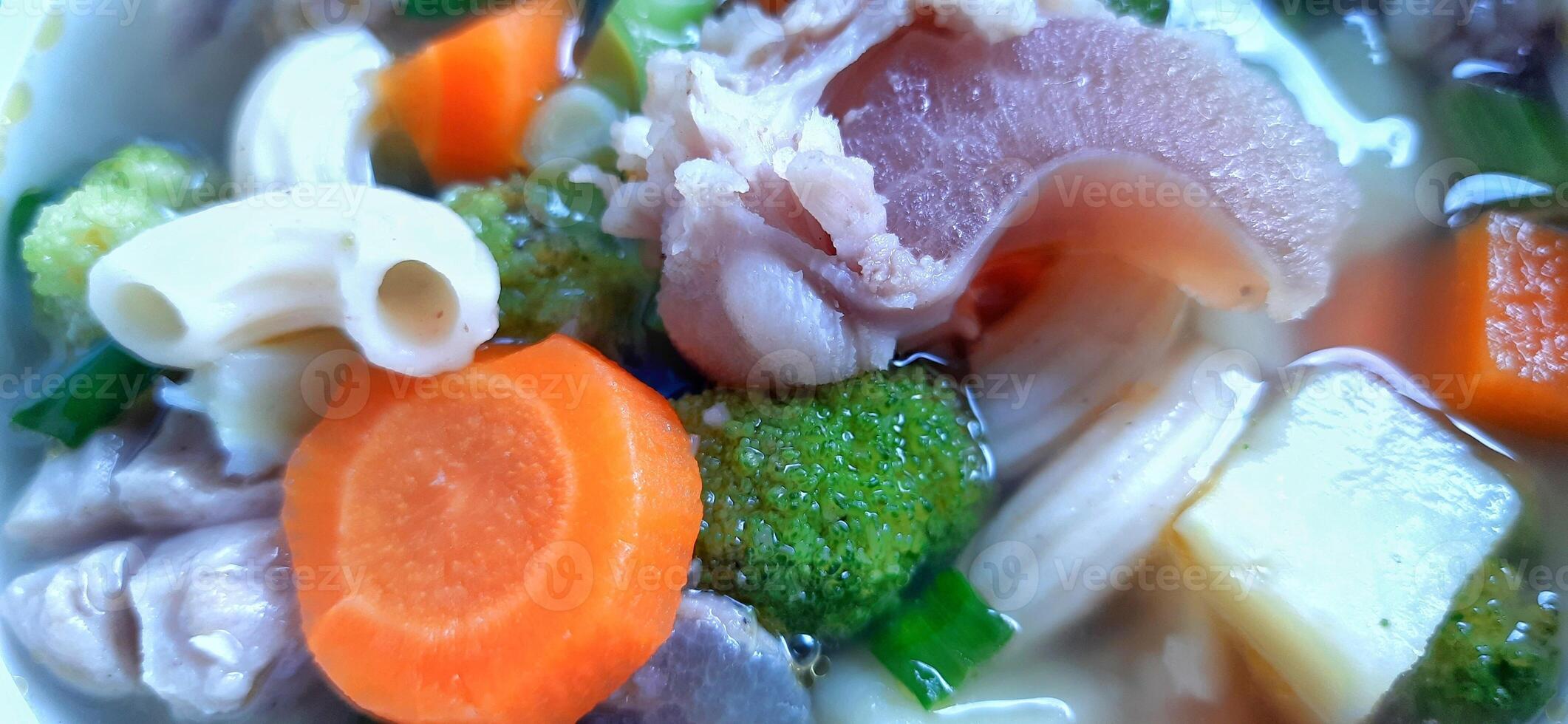 Sayur sop or vegetable with meat soup on the plate. Indonesian popular culinary. Healthy food and delicious photo