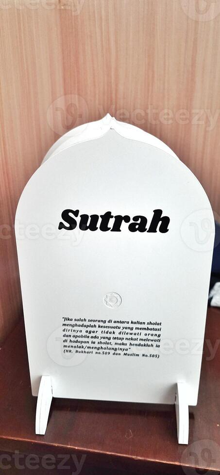 White board sutrah used for the barrier of people praying on the carpet of the mosque photo