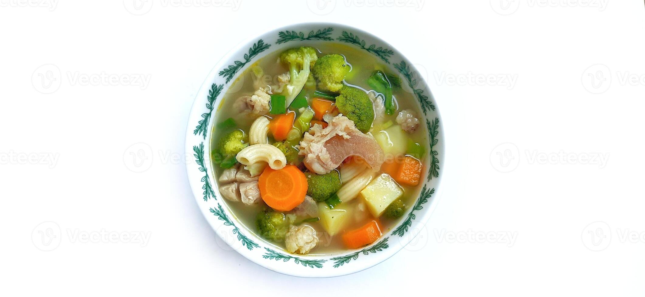 Sayur sop or vegetable with meat soup on the plate. Indonesian popular culinary. Healthy food and delicious photo