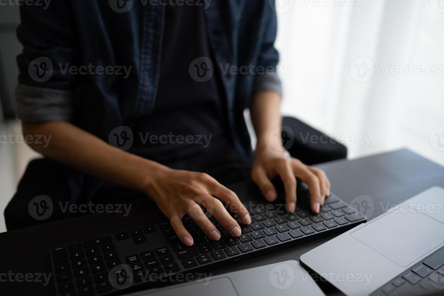 Asian man software engineer Working on Computer at office desk for writing program code IT Software Engineer finding errors tech support devops creating digital photo