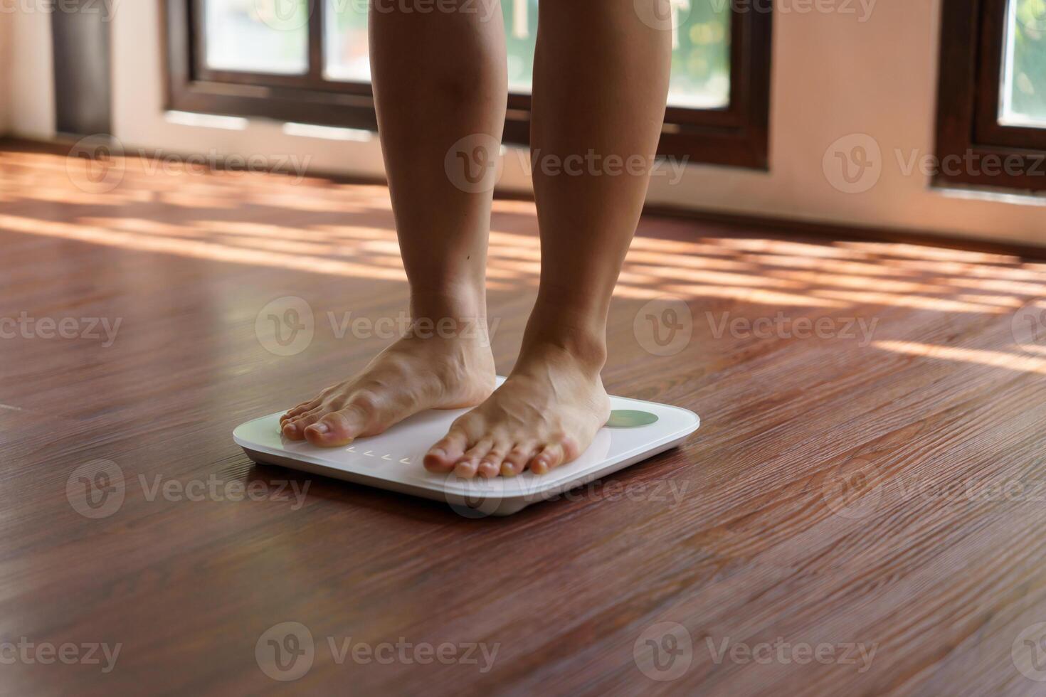 Fat diet and scale feet standing on electronic scales for weight control. Measurement instrument in kilogram for a diet control photo