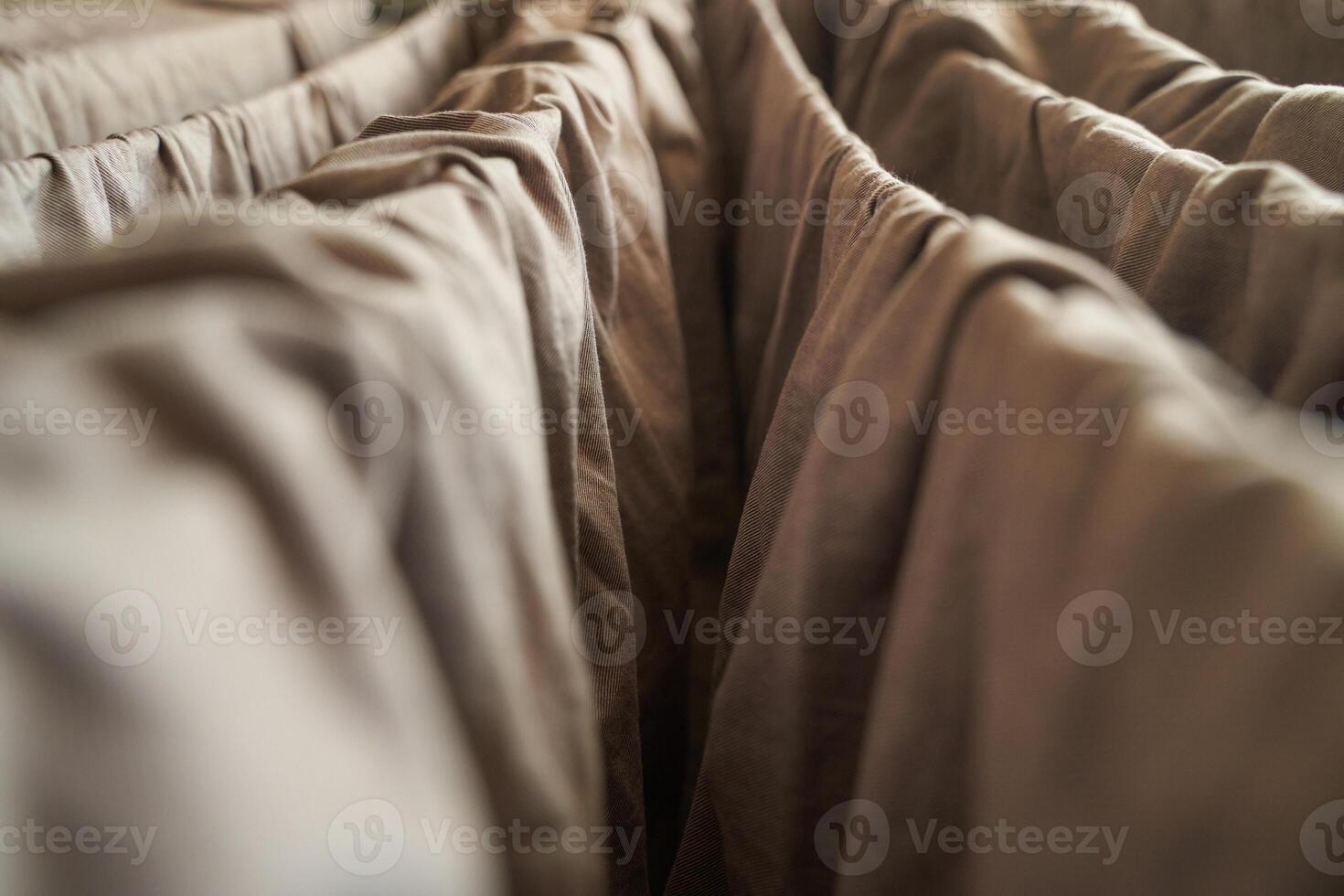 Close up of brown fabric folds creating abstract pattern with soft lighting. photo