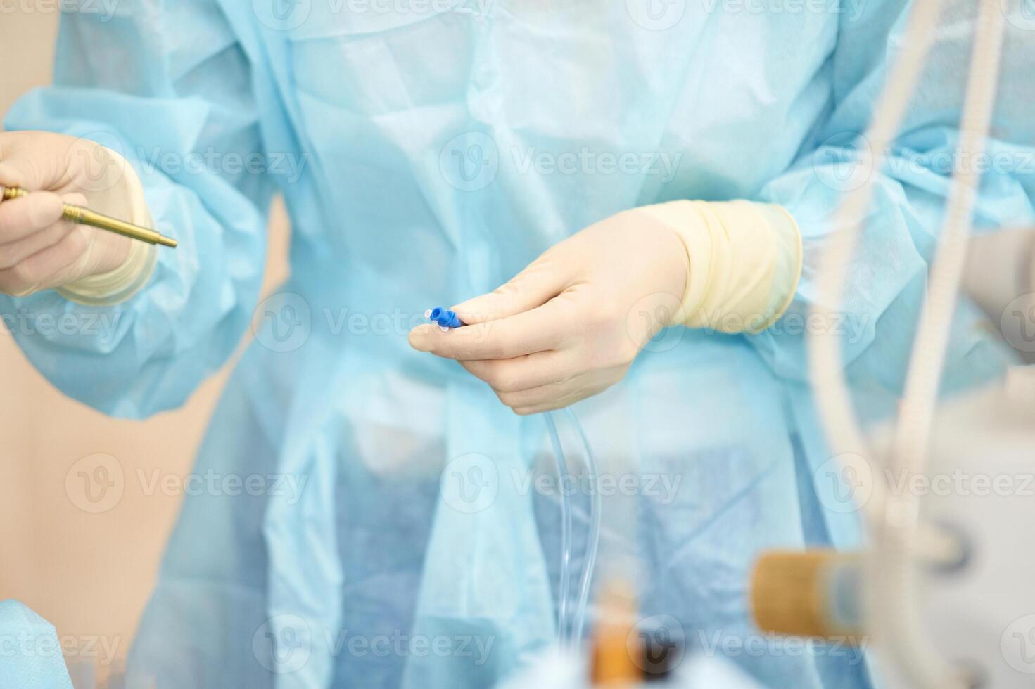 Healthcare professional in medical scrubs prepares equipment for surgical procedure in a sterile environment photo