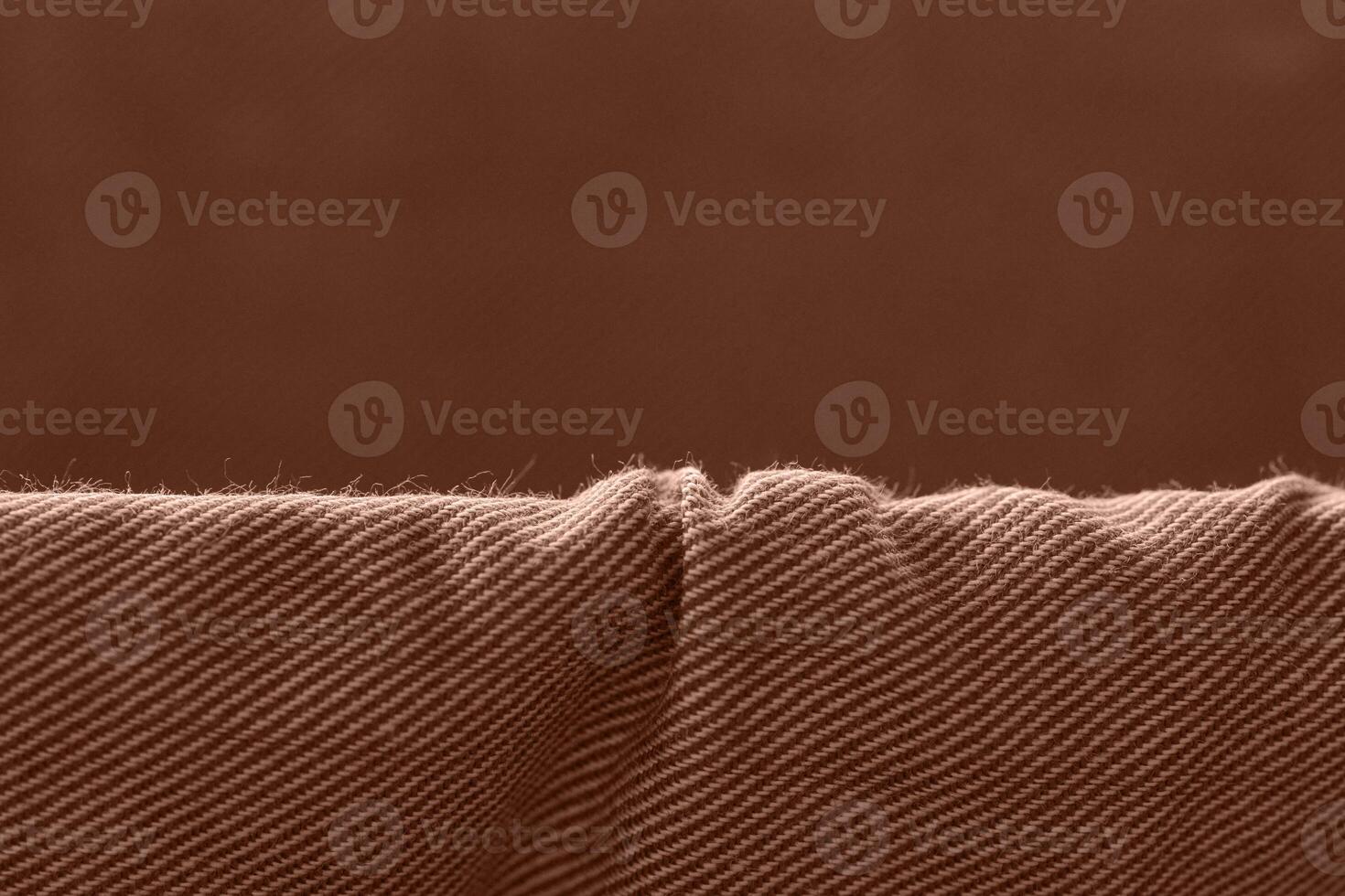 Close up of brown woven fabric texture with detailed pattern and soft lighting. photo