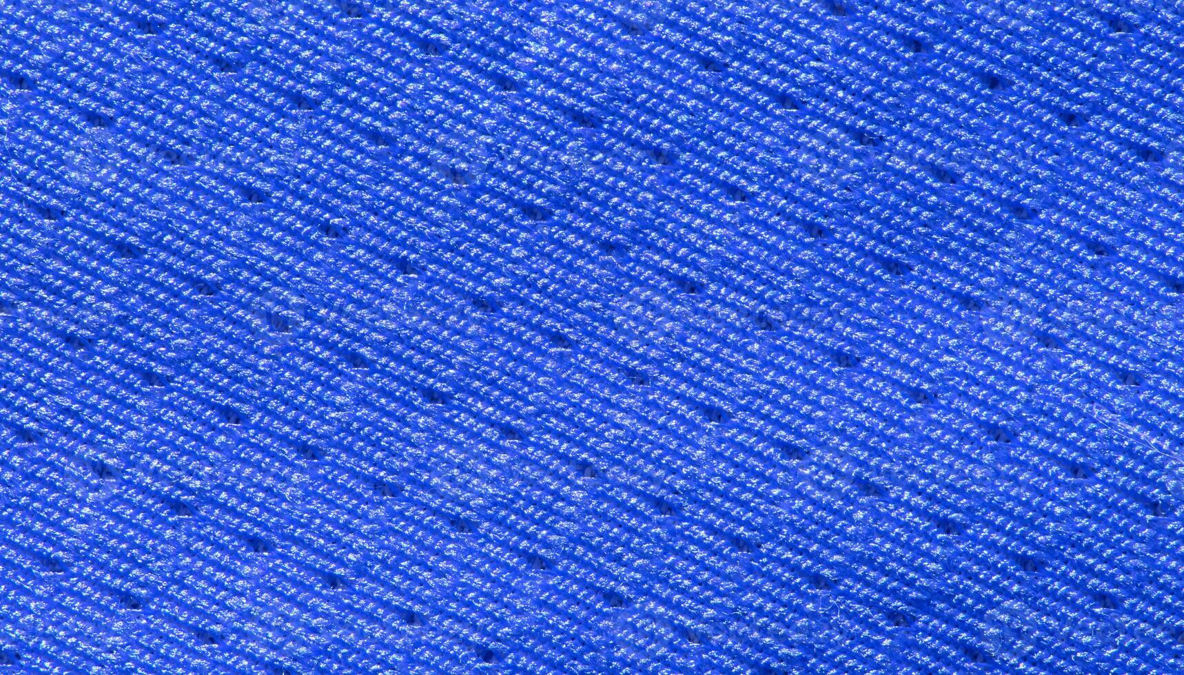 Vibrant blue textile fabric close up with detailed pattern and texture. photo