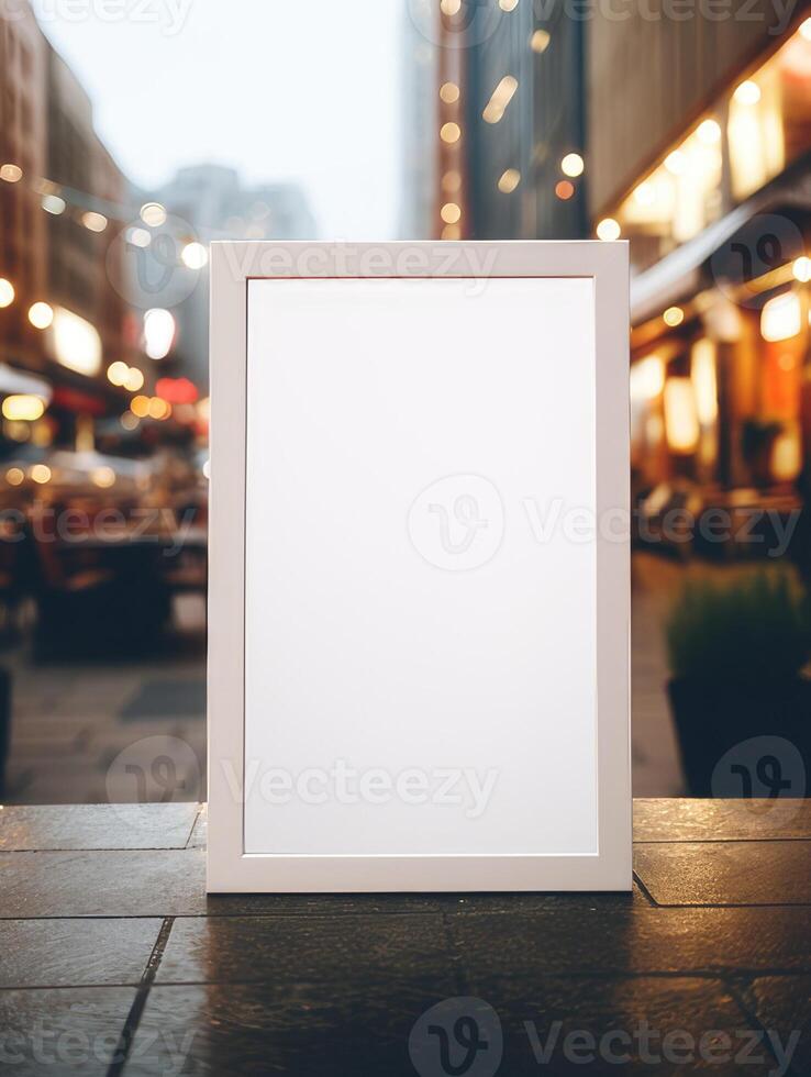 an empty small painting with a white frame on a blurred street background. photo
