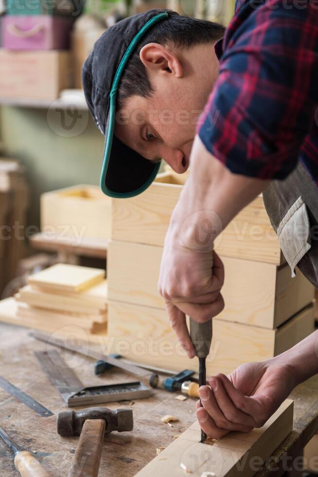 Carpenter working with a chisel photo