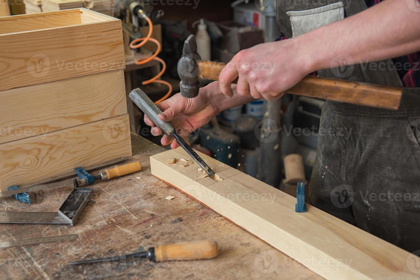 Carpenter working with a chisel photo