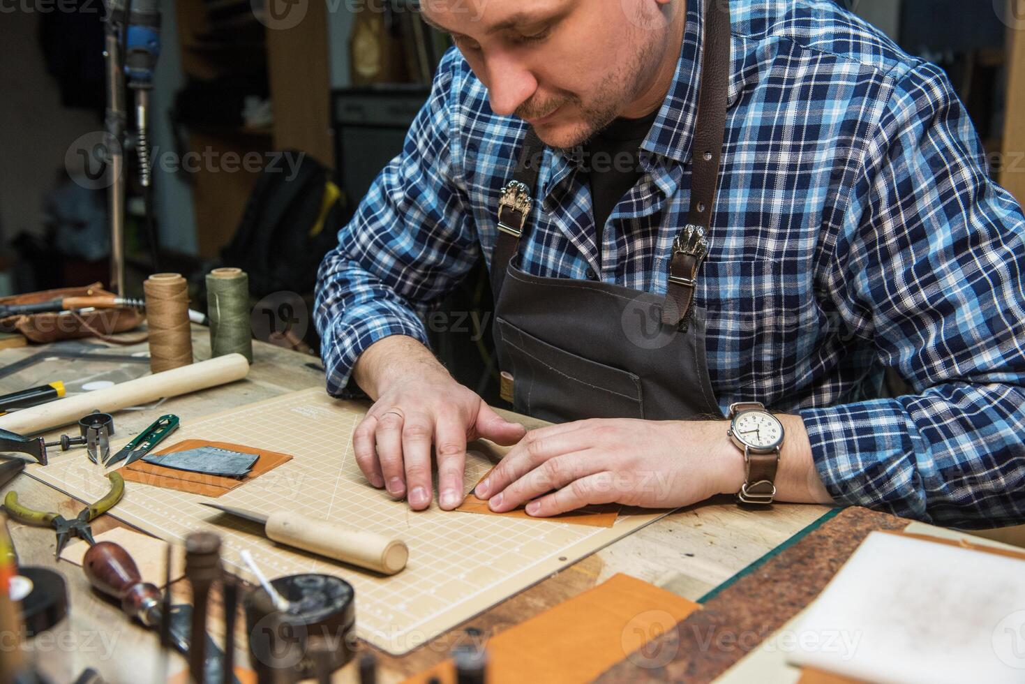 Concept of handmade craft production of leather goods. photo