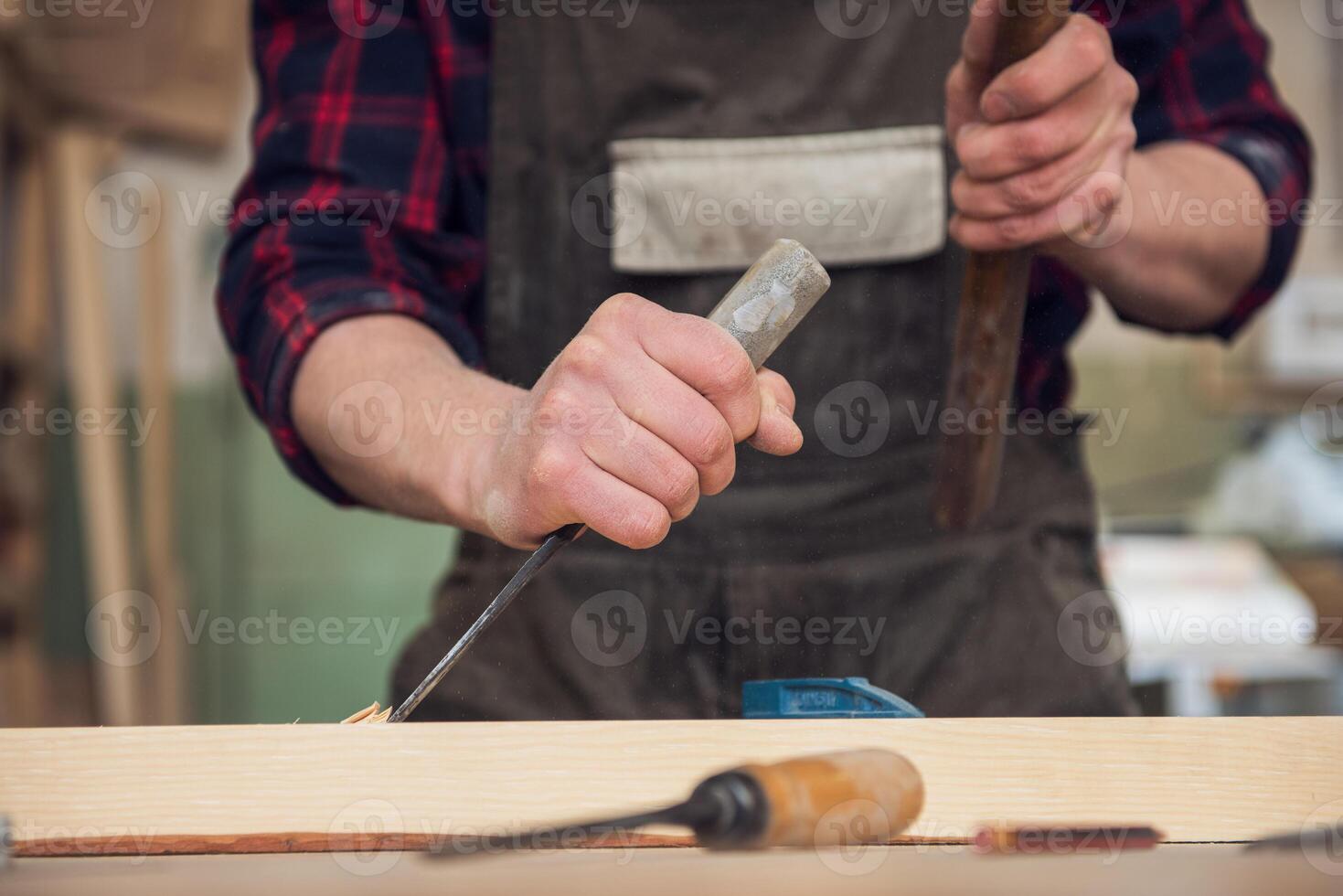 Carpenter working with a chisel photo