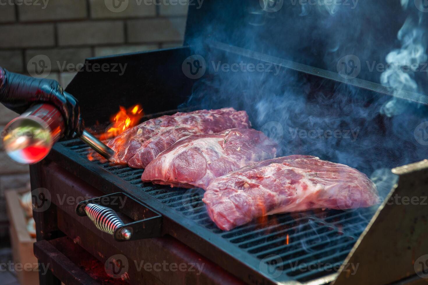 Pork meat steaks on the grill photo