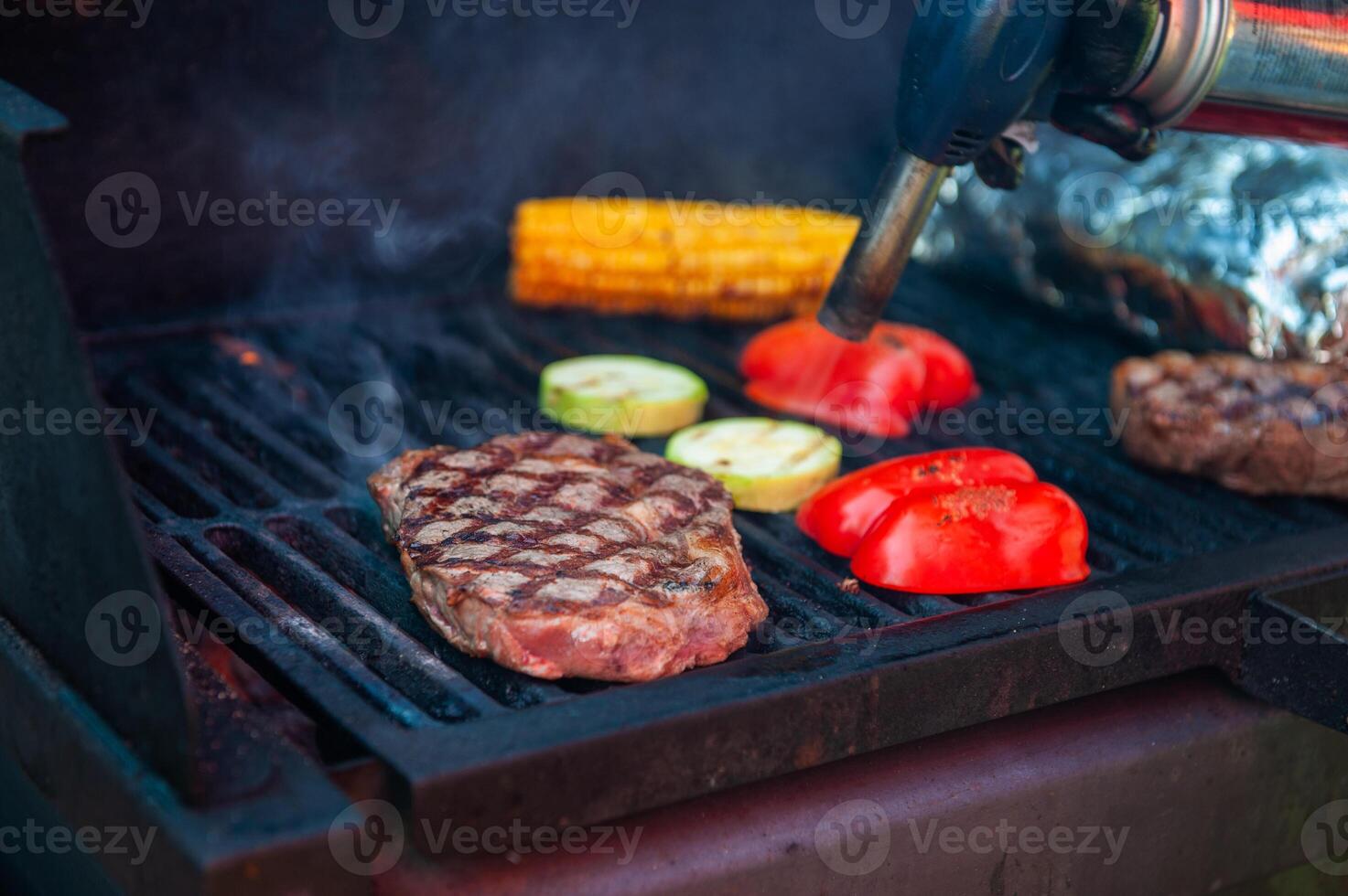 Beef steaks on the grill with flames photo