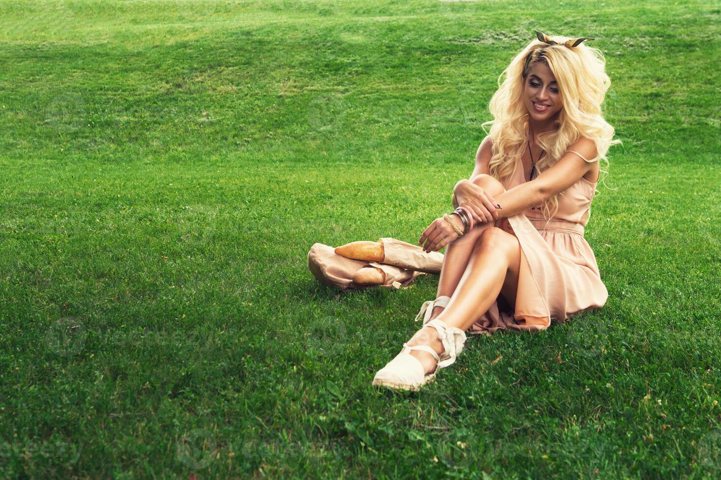 Beauty blonde alone young woman resting in the park photo