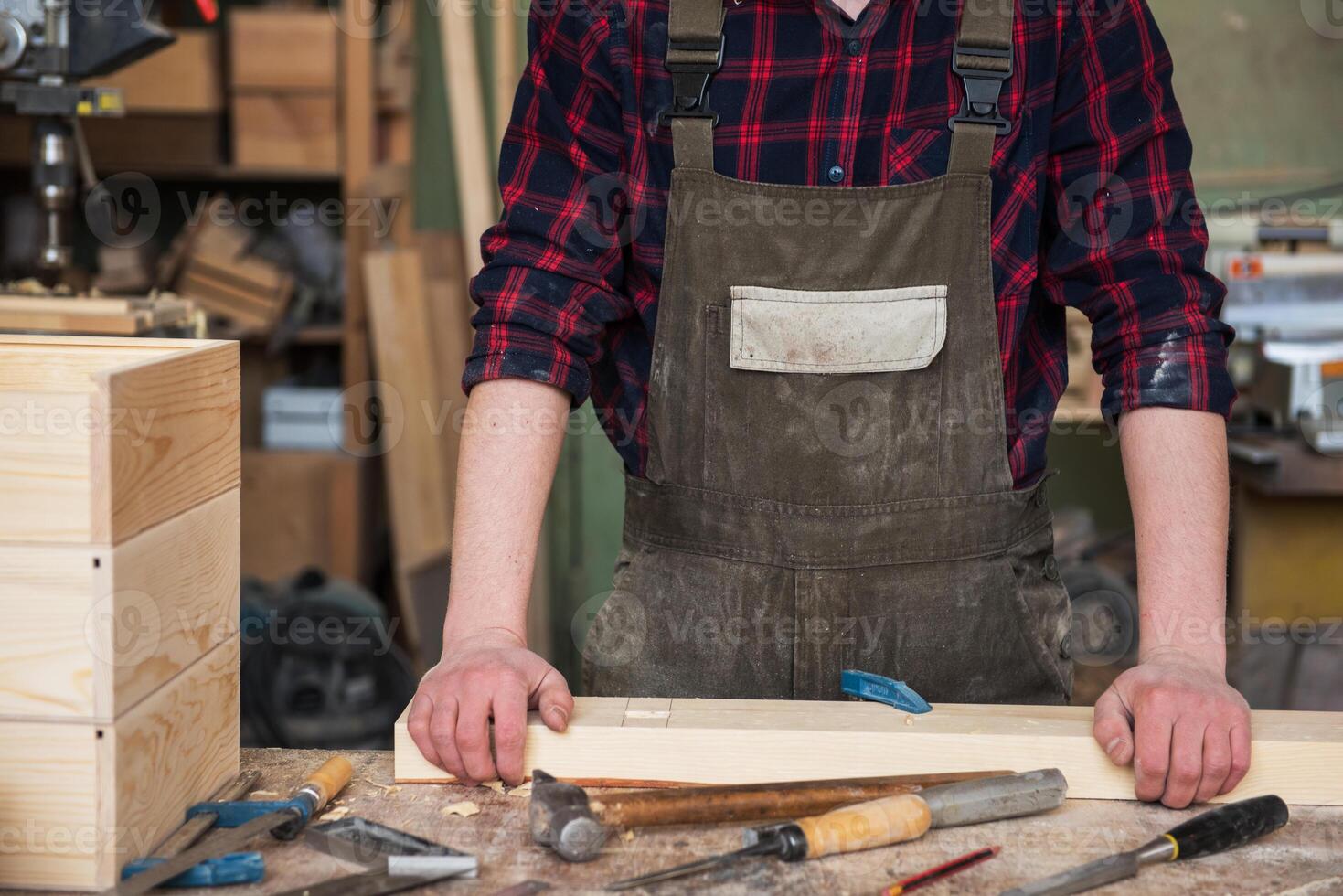 Carpenter working with a chisel photo