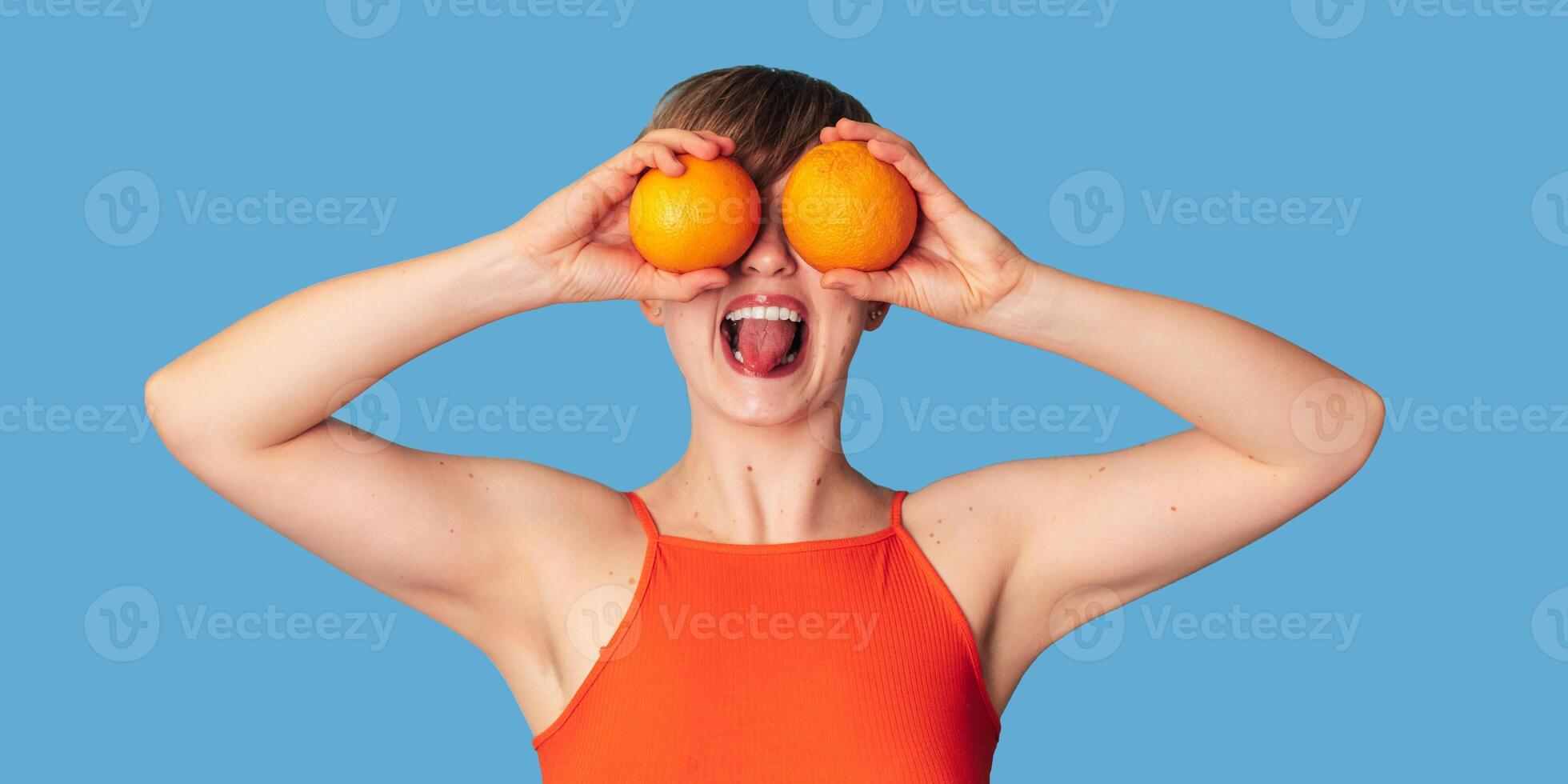 Smiling Caucasian girl with citrus oranges in her hands. Panoramic banner, free space. Vitamin C. photo