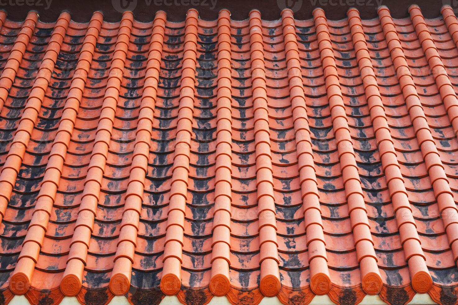 A close-up image of the traditional tile roof pattern of an old Buddhist temple. Texture for the background photo