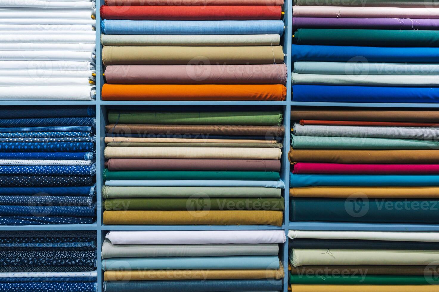 Layers of different fabrics with different colors in the stack. photo