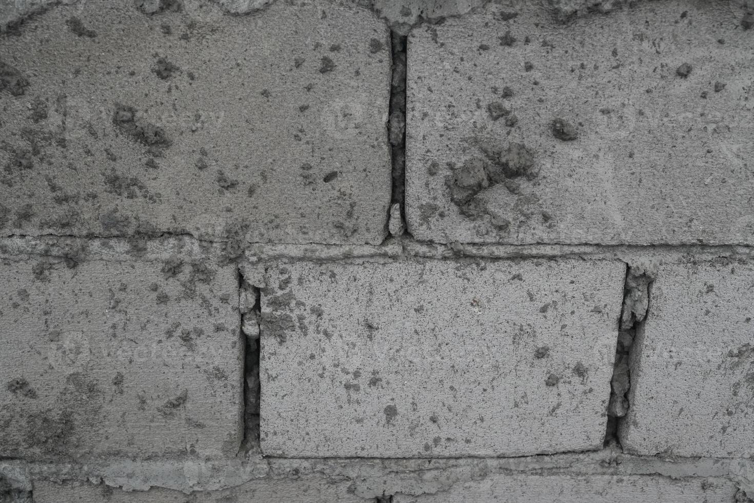 close image of raw Old concrete block wall background and texture photo