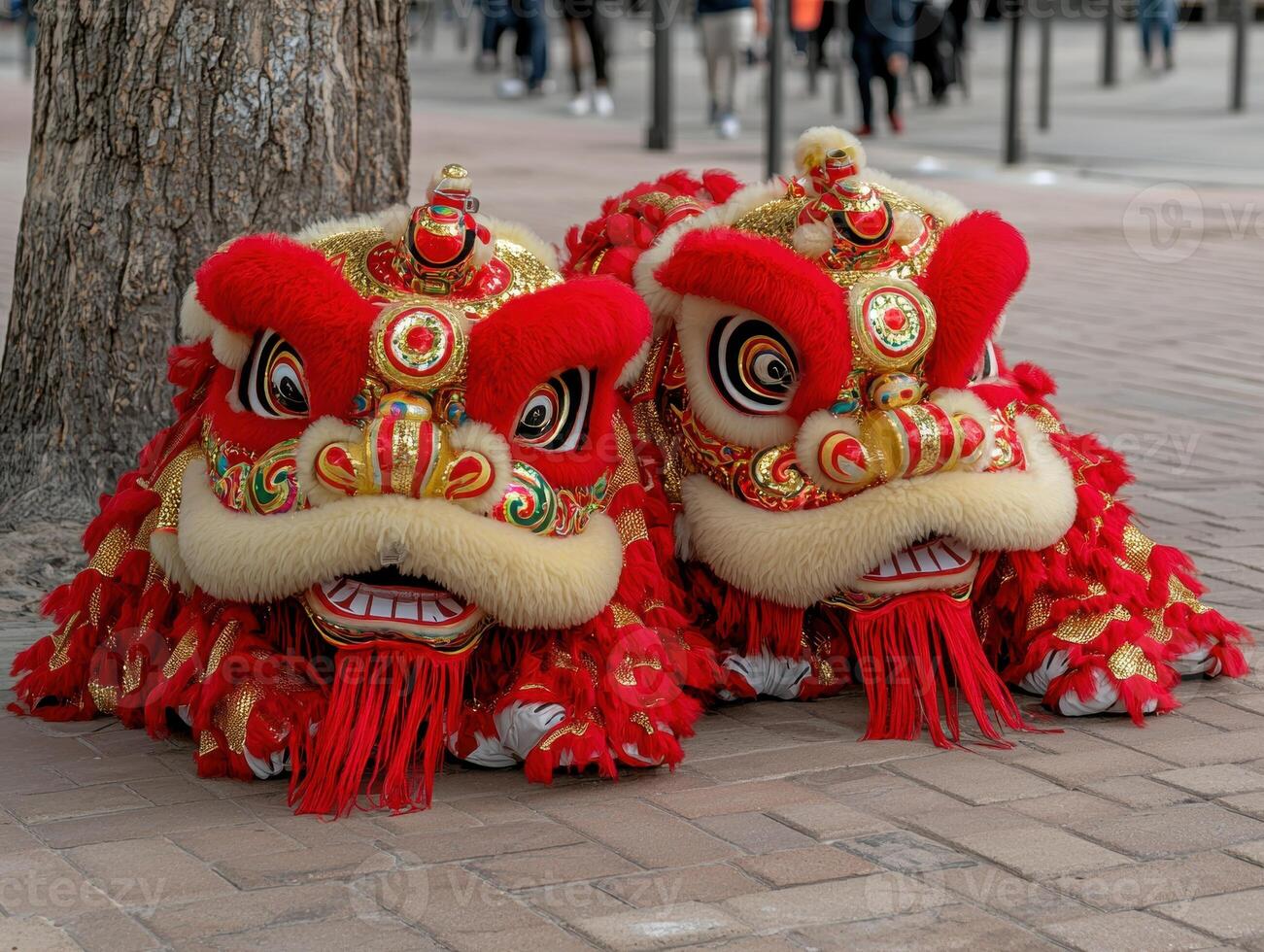 Two vibrant lion dance costumes rest on a city sidewalk photo