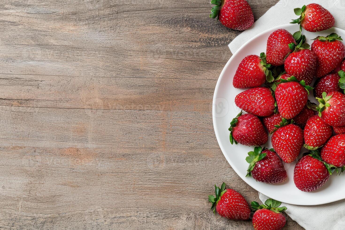 Fresh strawberries on a rustic wooden table photo