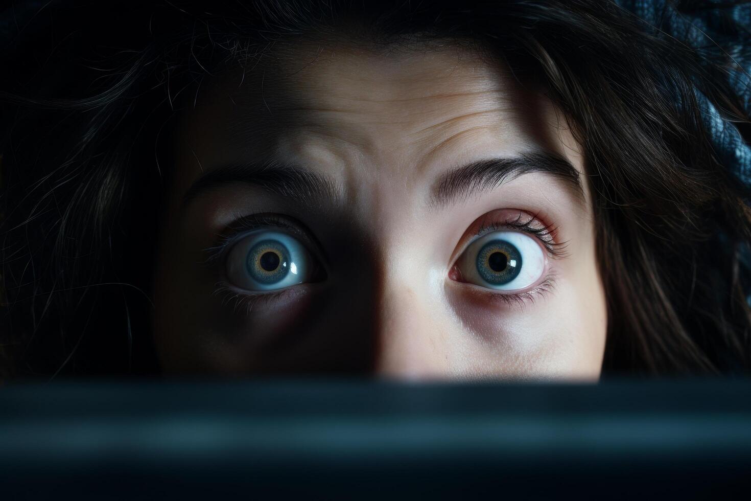 Mysterious eyes peering out from the darkness photo
