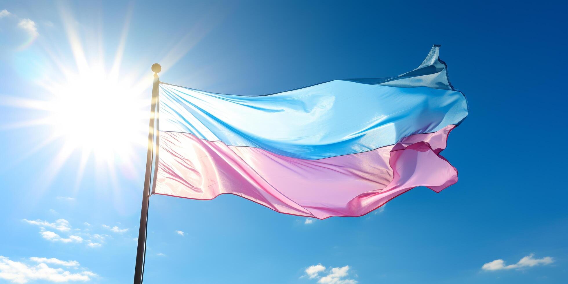 Waving national flag against blue sky with sun photo