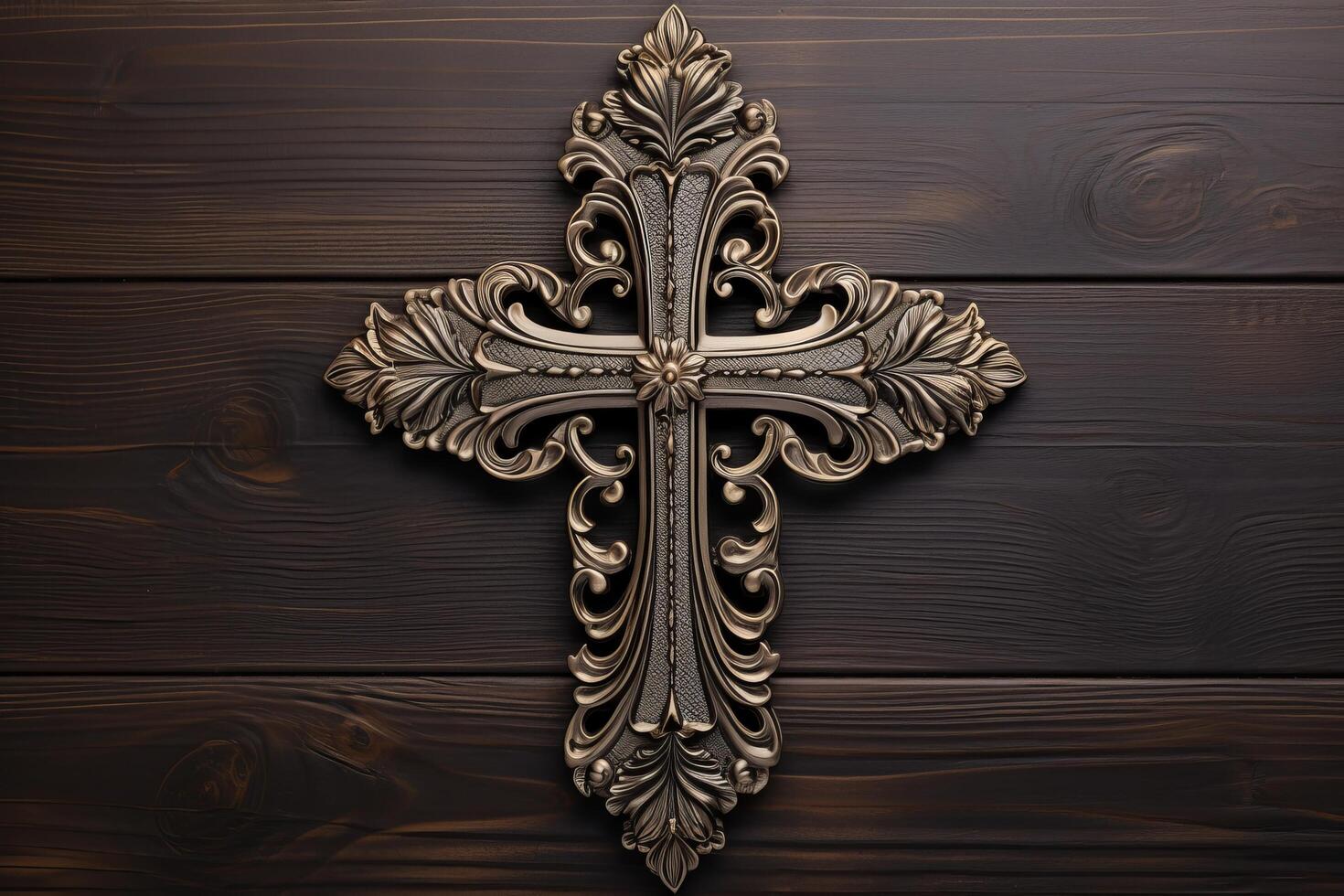 ornate christian cross on wooden background photo