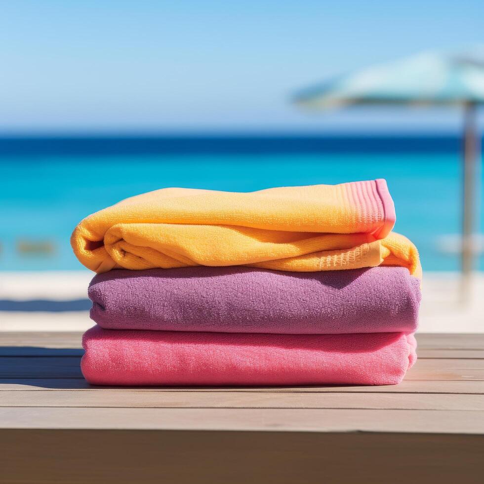 Colorful beach towels on wooden deck with ocean view photo