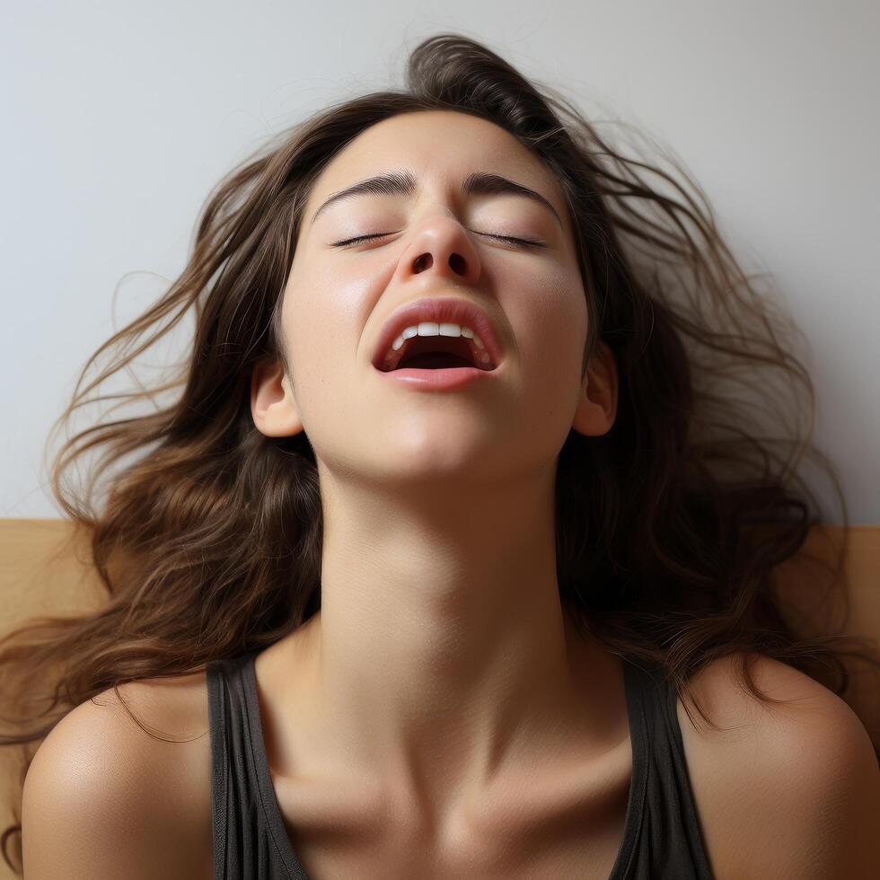 young woman with eyes closed and hair blowing in the wind photo