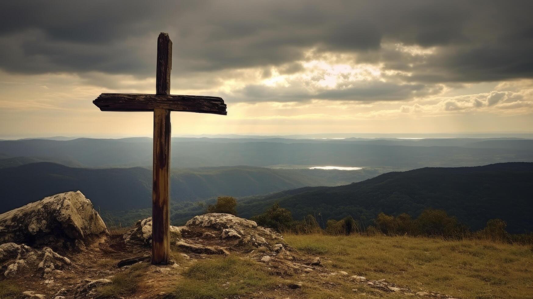 Wooden cross on a hilltop overlooking a scenic mountain landscape photo