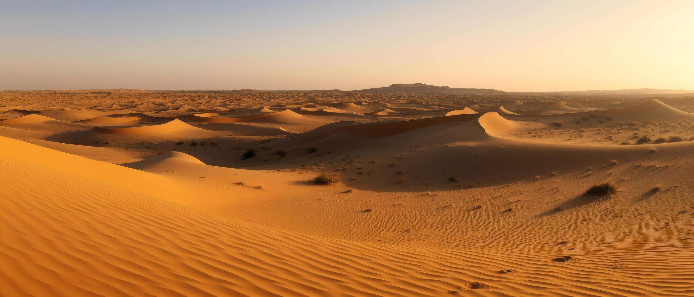 Vast desert landscape with sand dunes at sunset photo