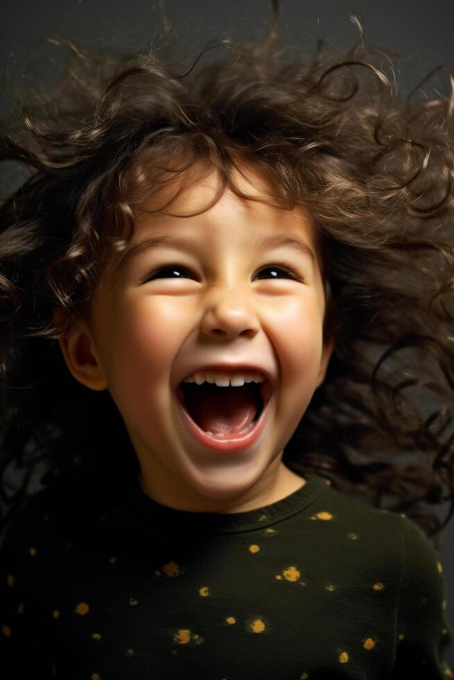 Joyful child with curly hair laughing photo