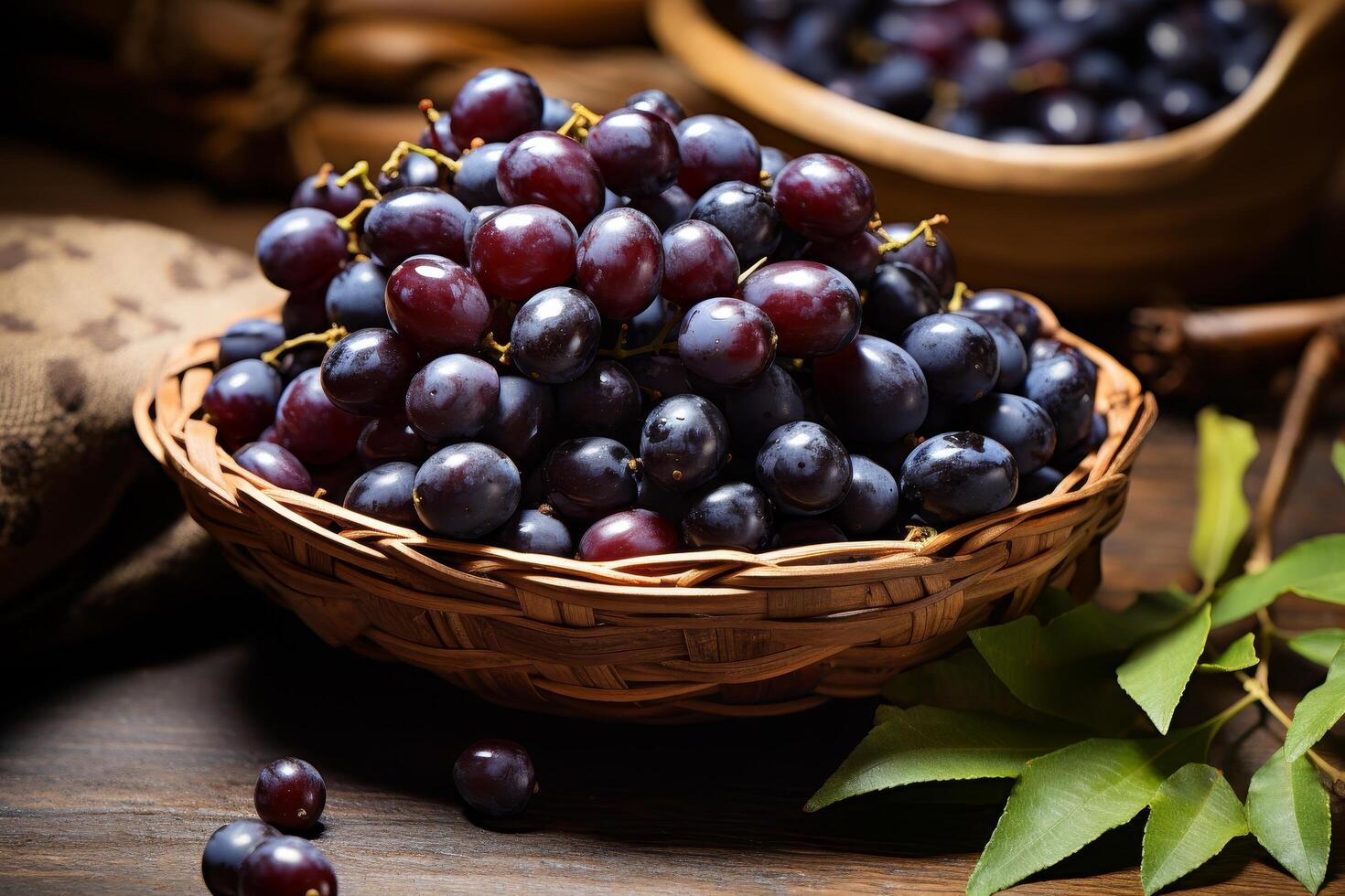 Ripe red and purple grapes in a wicker basket on a wooden table photo