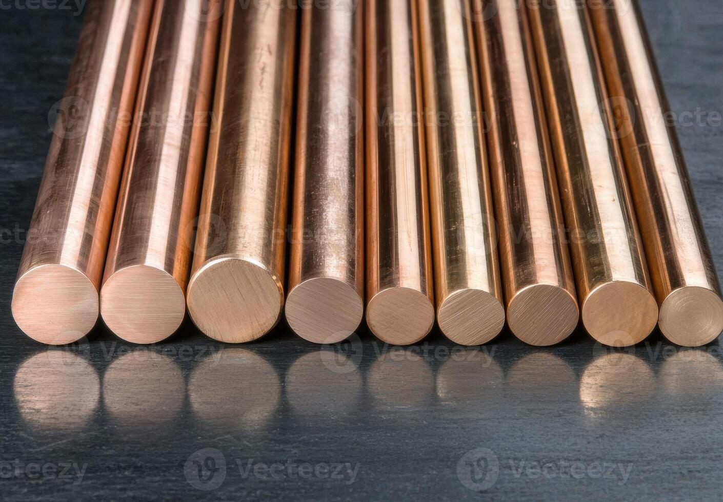 Close up of shiny copper rods on a dark background photo