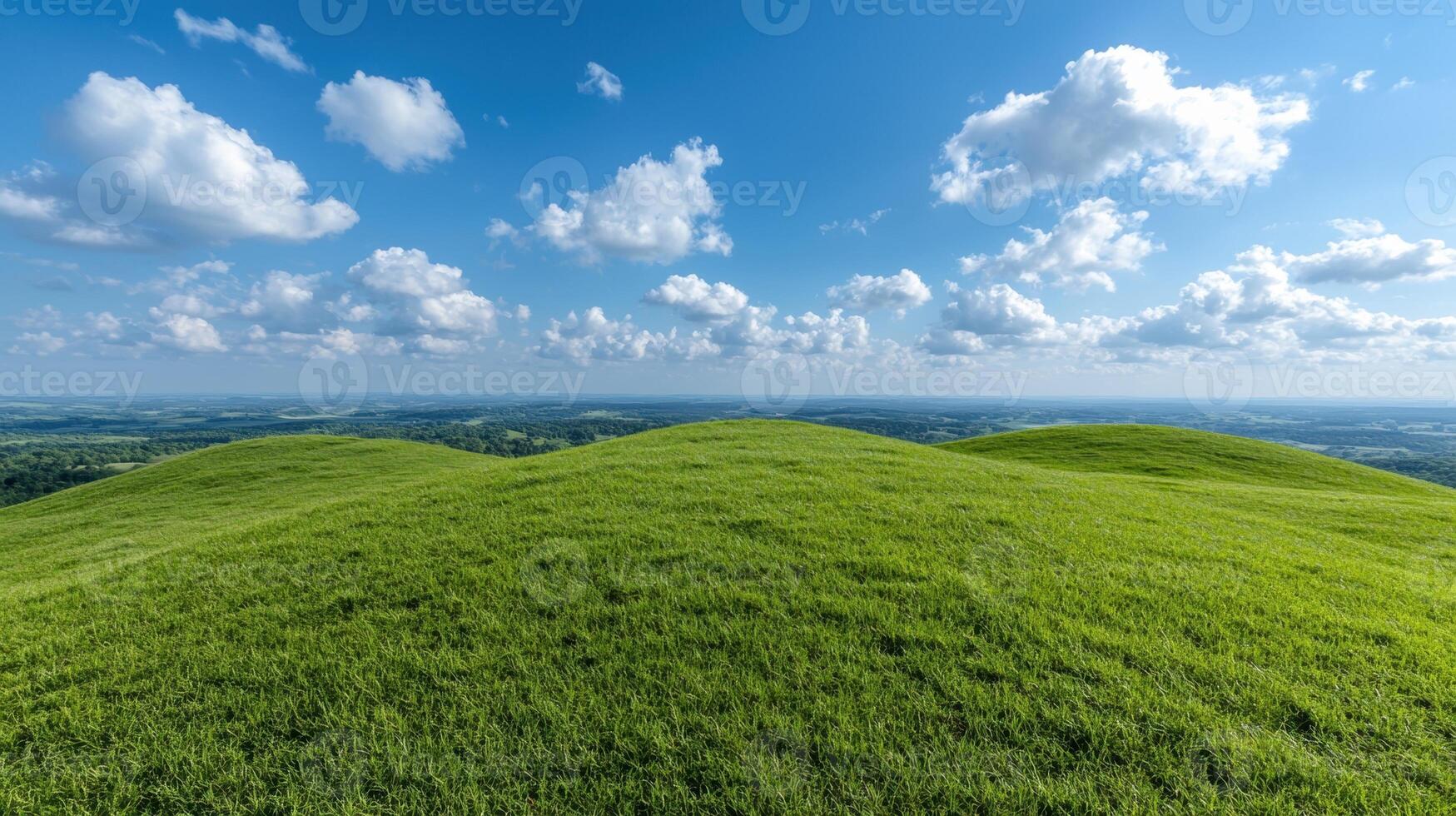 Rolling green hills under a bright blue sky with fluffy white clouds photo