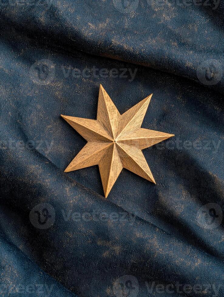 A golden star on a blue cloth photo
