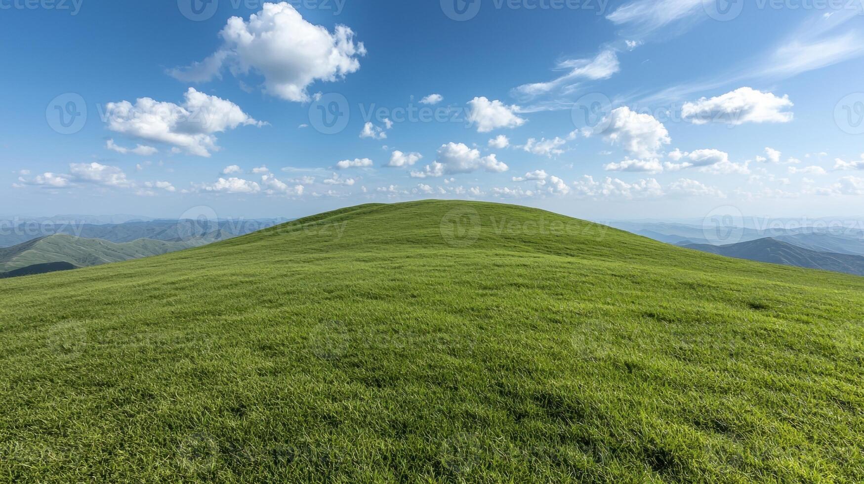 Rolling green hills under a blue sky with fluffy white clouds photo